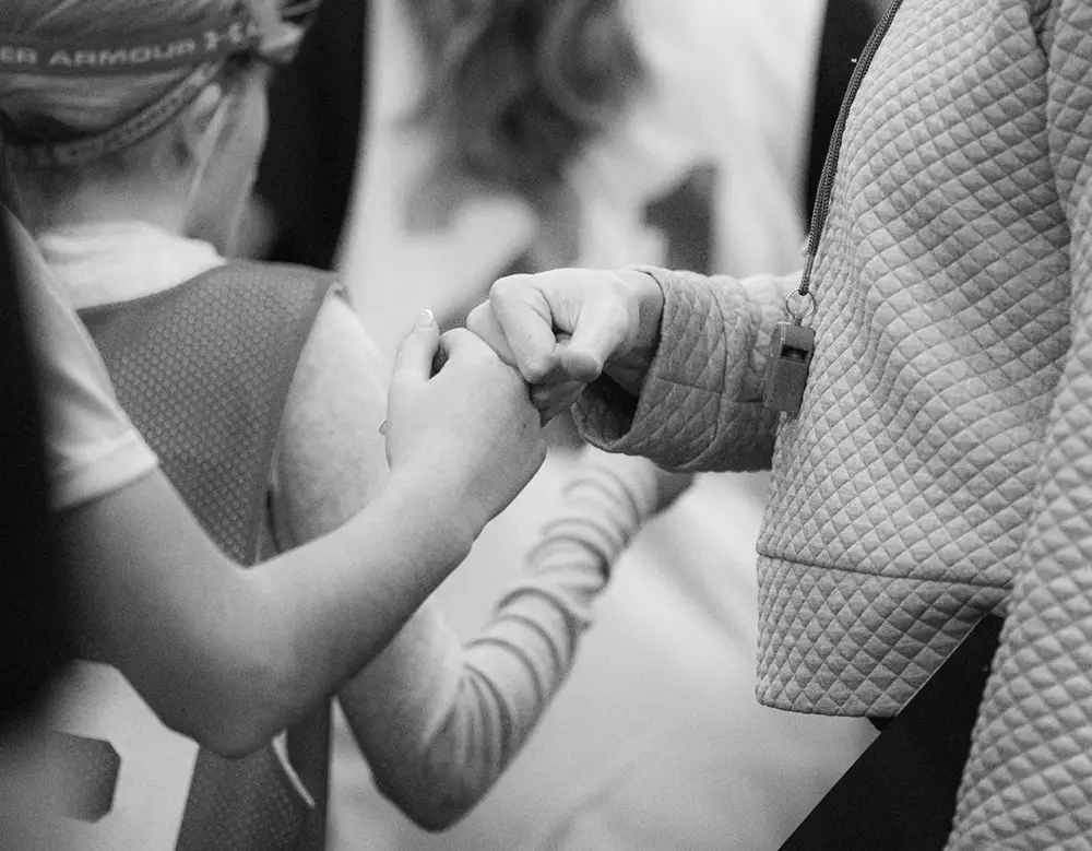 Lacrosse Canada development team members fist bump their parents